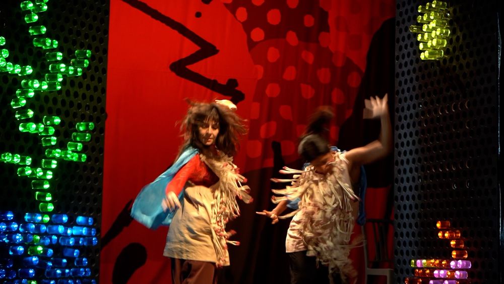Two women dance.