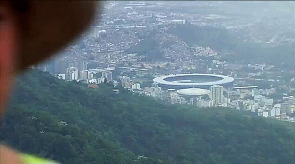 an aerial view of a city with a stadium in the background