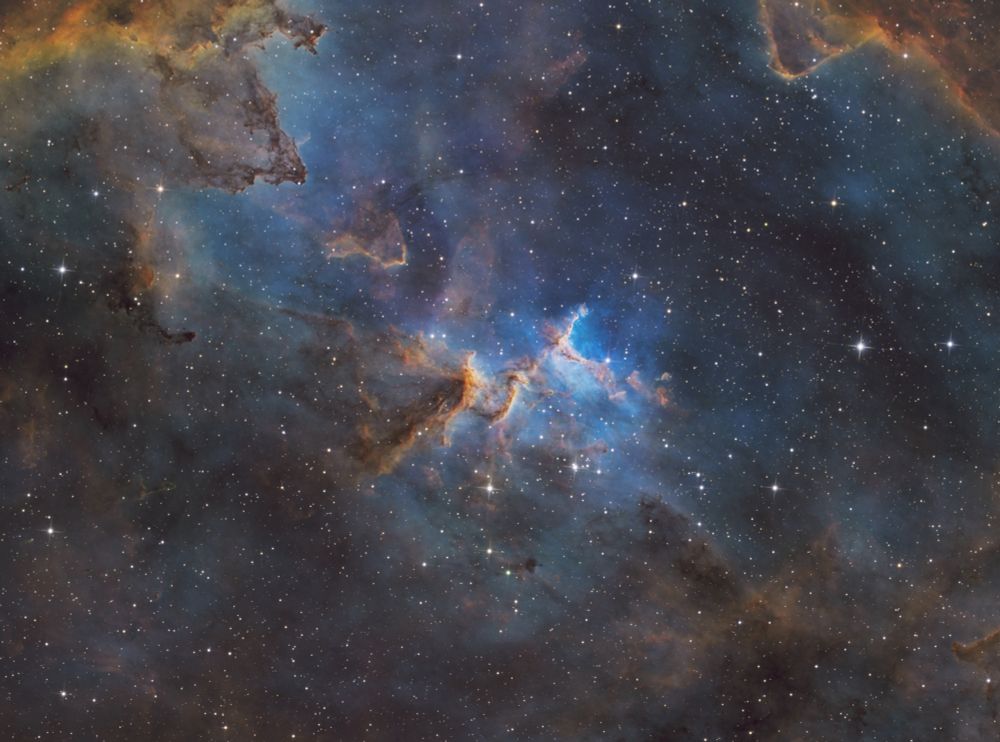 Melotte 15 is the heart of the Heart nebula. It is a complex field of dark dust lanes and brighter yellow/orange/red spires in a sea of vibrant blue dust. 