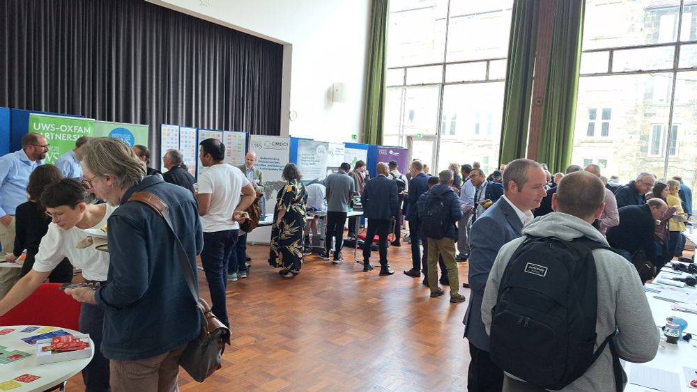 A photograph of attendees at the UWS Research Festival looking at the different stalls.