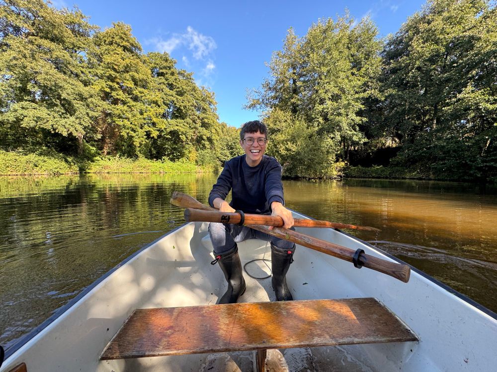 Person on a small boat in pond