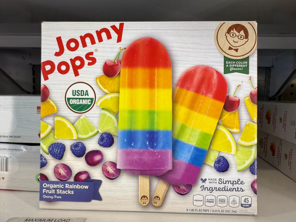 A photograph of an ice pop product called “Jonny Pops“ featuring beautiful rainbow striped ice pops.