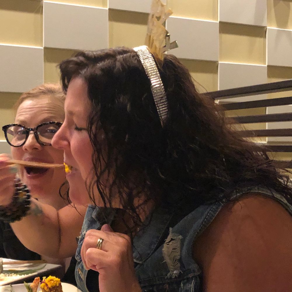 Restaurant Scene: Woman, just placed huge roll in her mouth while an astonished friend looks on. Happy 50th Steph! 