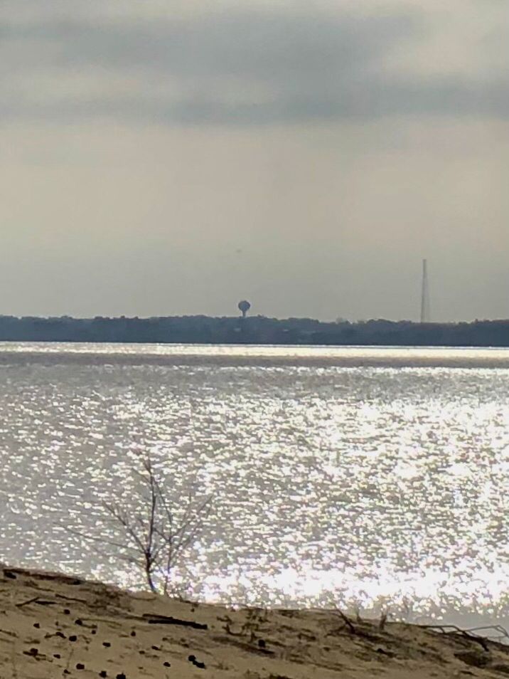 Sun sparkles on the sound with Roanoke Island in the background 