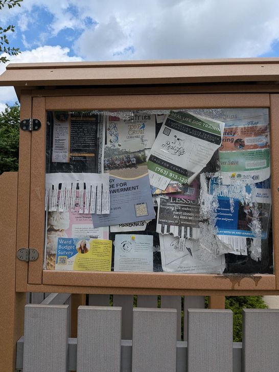 katie cashman budget survey placard and qr code posted on a park bulletin board.