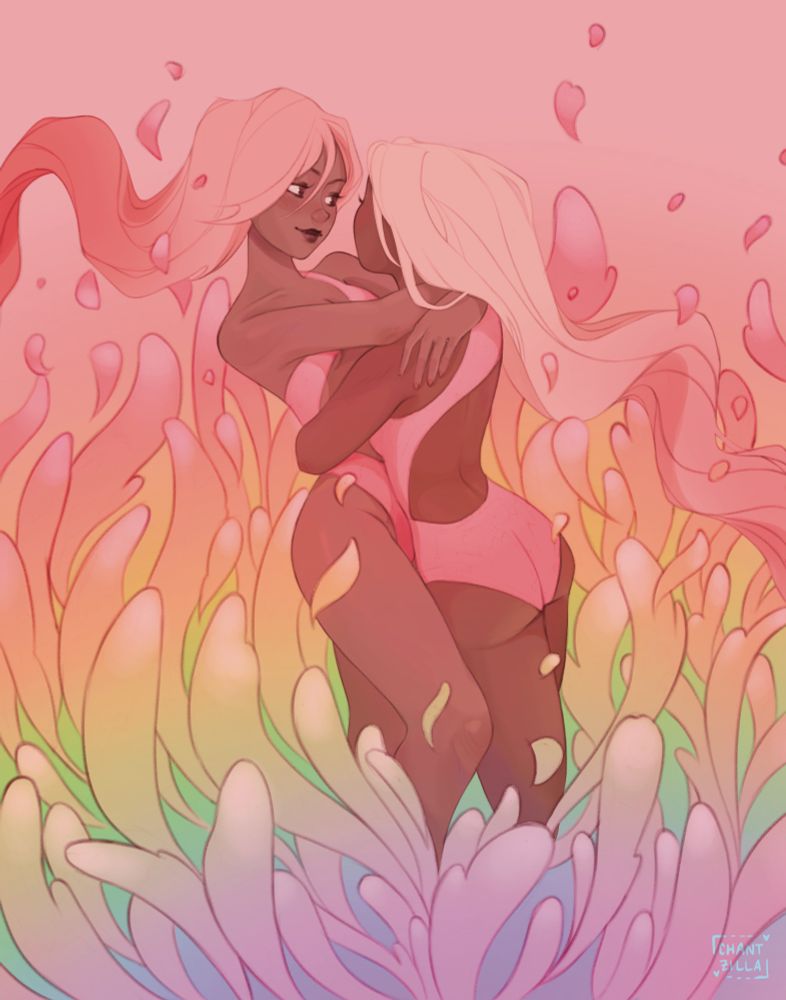 Two women with long, flowing hair embracing. They are standing in a patch of rising/floating rainbow-coloured petal-like structures 