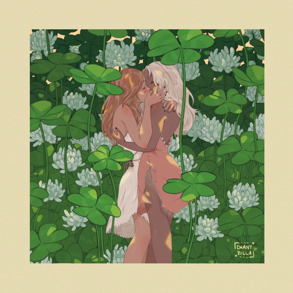Two women kissing, surrounded by large white clovers and under sun-dappled lighting 