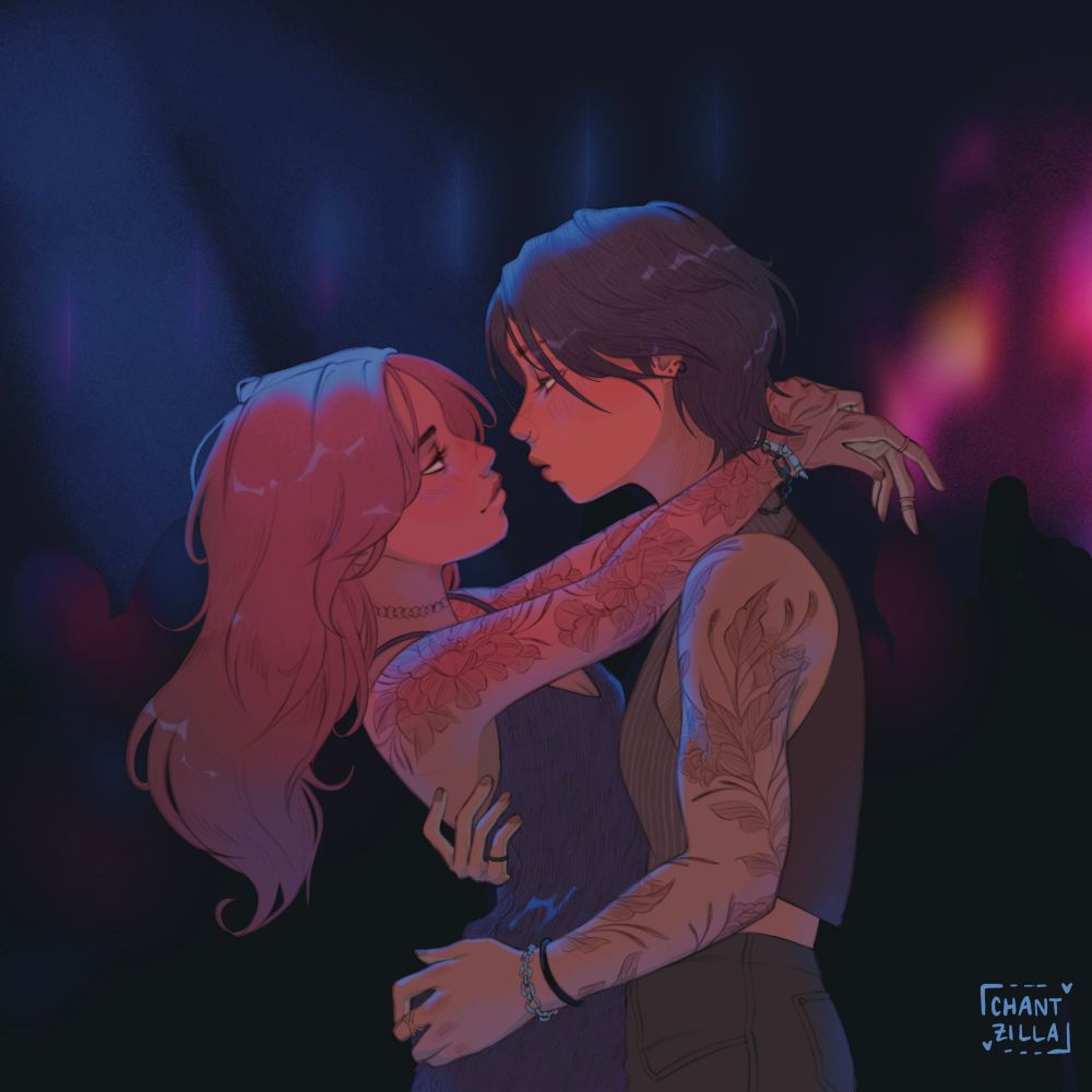 Two women embracing under blue/pink lighting 