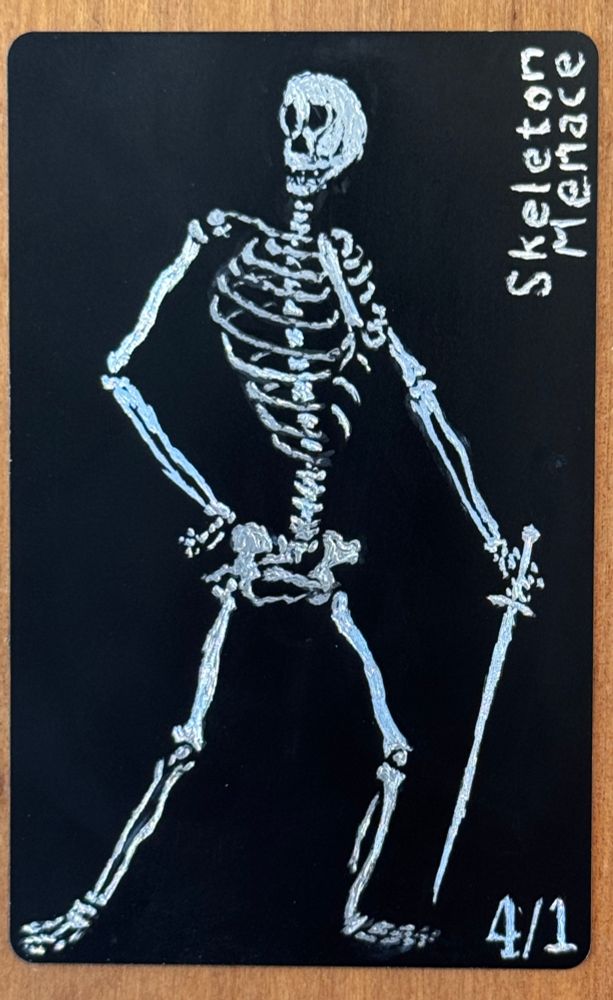 A 4/1 skeleton token with menace, etched in metal
