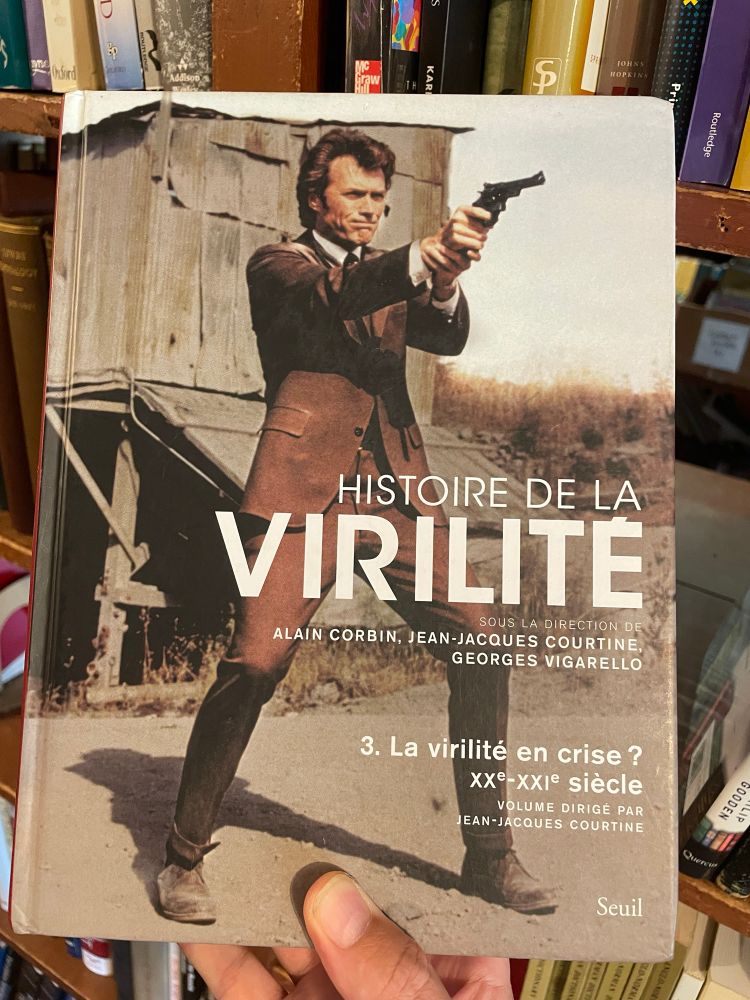 A book titled: Histoire de la Virilité: La virilité en crise? which has a large photo of Dirty Harry, played by Clint Eastwood, firing a gun