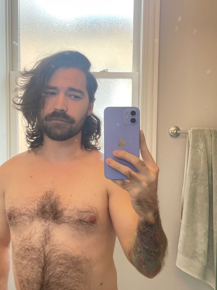 Mirror selfie showing off how long my hair has gotten, officially a bit down my back