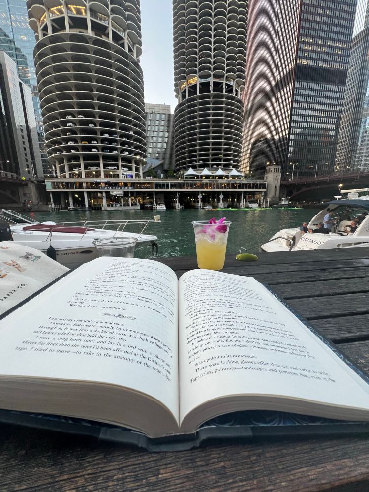 A book and a drink overlooking the Chicago river and river walk