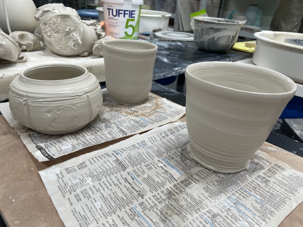 3 smaller pieces of hand thrown pottery. 2 might turn into mugs. One is a rounded type thing… too small for a bowl, too tall for a dish, I’ll try to think of a better name for it…. 
