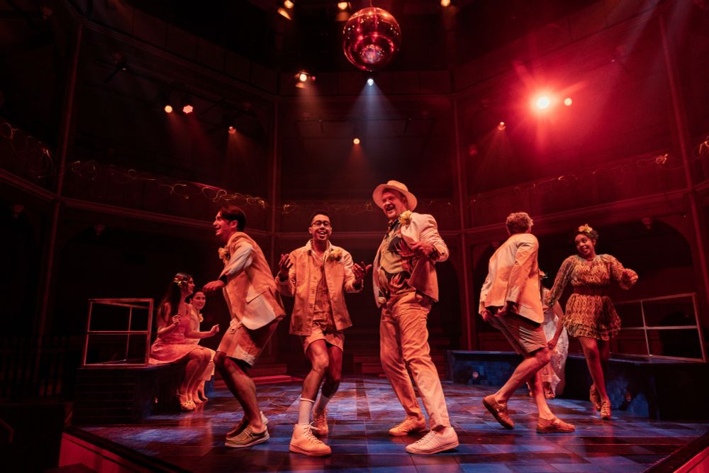 People dancing on a stage in a theatre. 