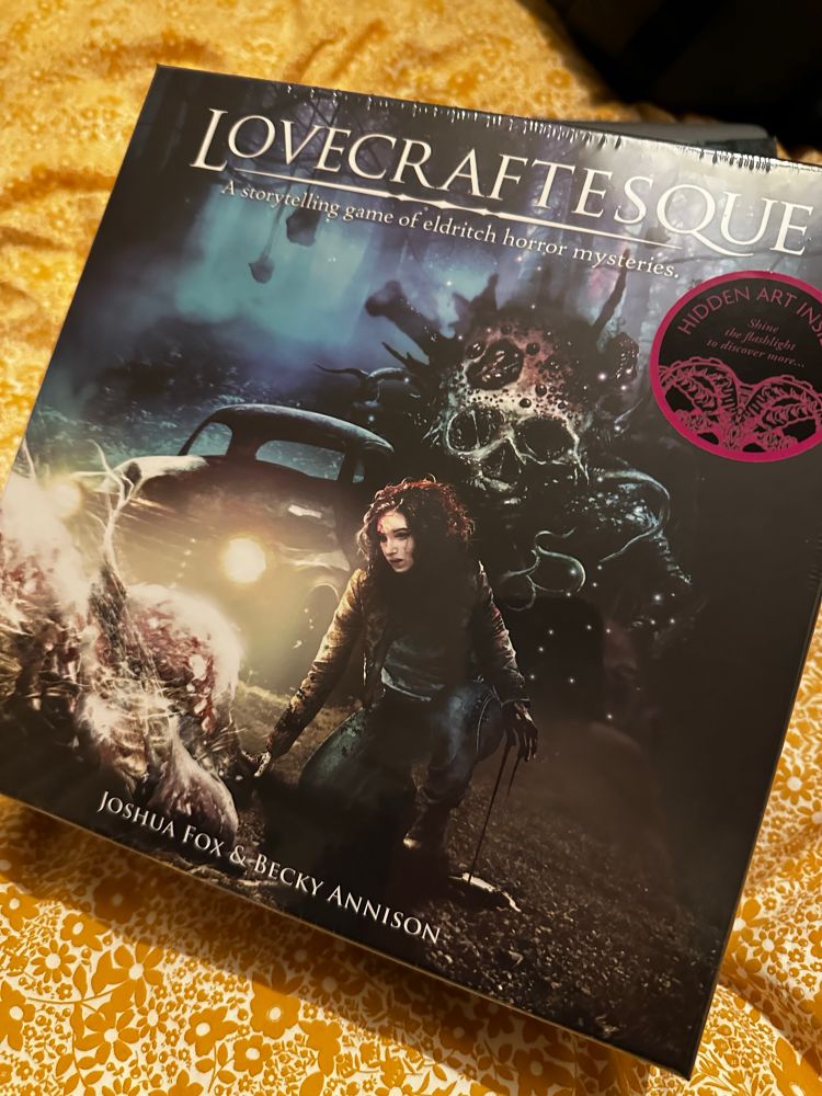 The front of the Lovecraftesque 2e boxed set. It shows a woman examining a corpse with an old time truck in the back and some weird, deathly visions encroaching on reality on the other side.