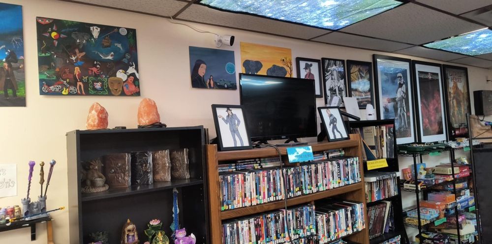 Game store, where three pieces of Amy King art are posted.