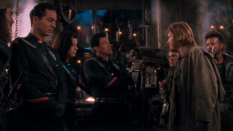 A scene from Demolition Man in which Jack Black is standing slightly behind Denis Leary