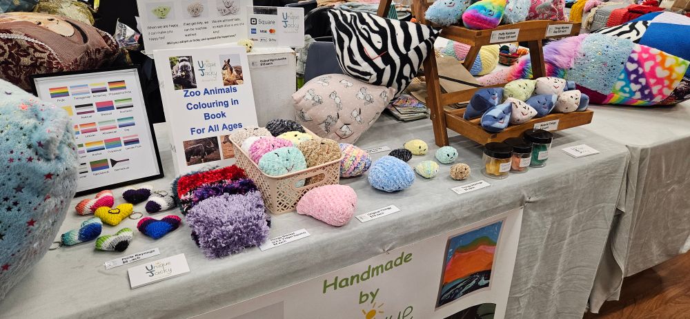 A colourful display of sensory toys, including Thingy sensory toys and pride heart keyrings. 