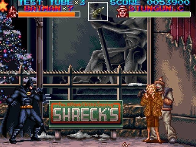 batman returns for snes, image of the side scrolling brawler; batman on the left, a clown holding selena kyle on the right