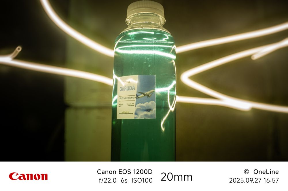 Long exposure photo with bottle  with light in the back and yellow background 
With canon eos 1200d using F/22.0 ,shutter speed 6 second and with iso 100  with 20mm 
