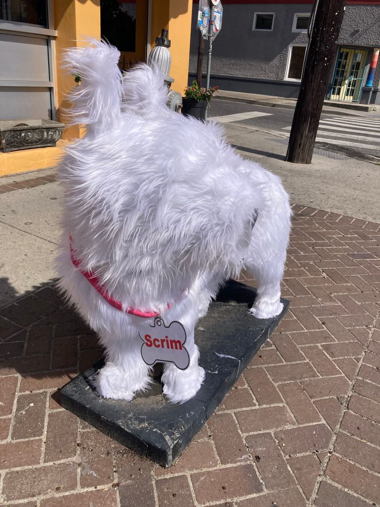 Art sculpture of New Orleans legend, a white dog called Scrim. 