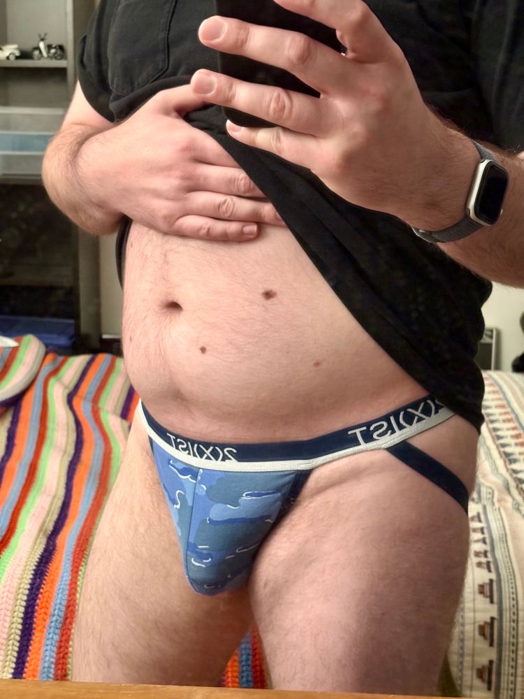 Brady in a blue camo jock, feeling self conscious about my belly and that fold below my waistband 