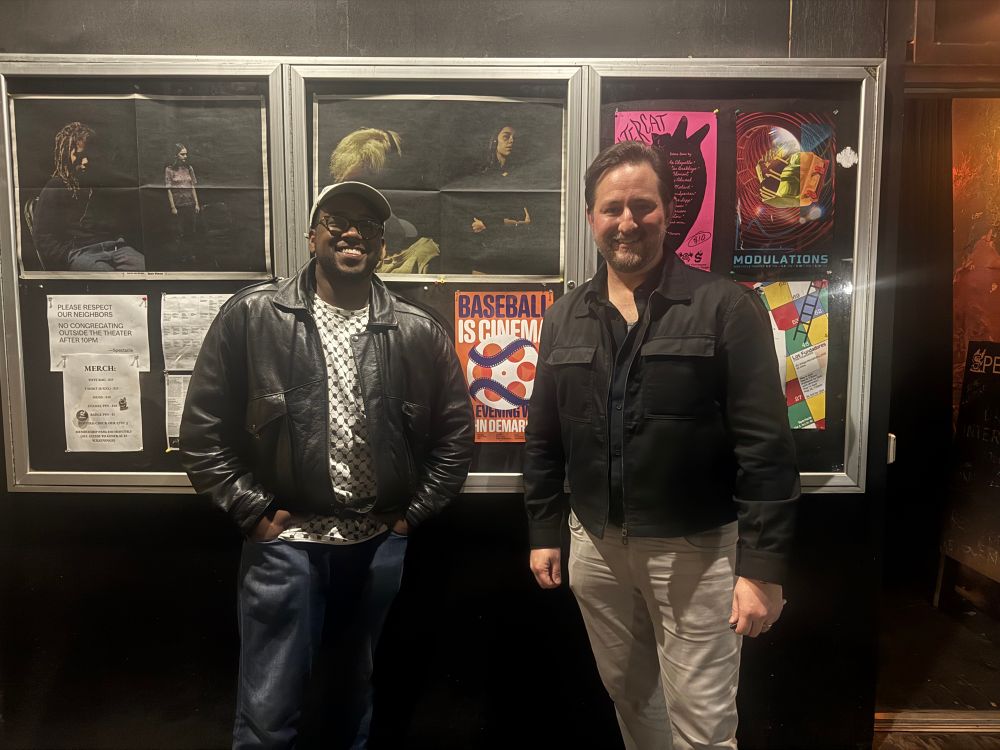 handsome men posing in front of microcinema