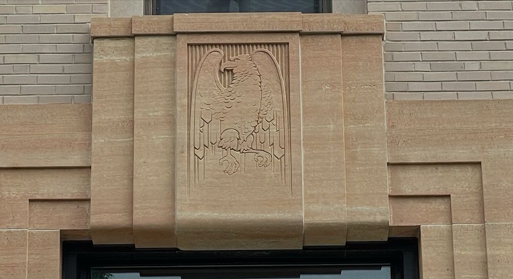 Limestone carving of a stylized eagle looking to the left (from photographer’s perspective).