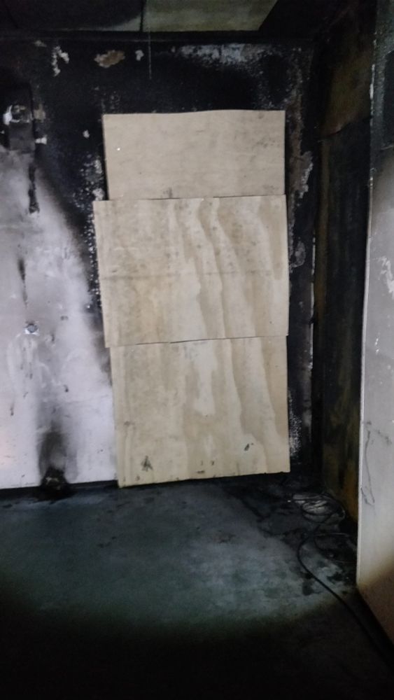 Boarded up doorway to a burned down apartment after fire was extinguished.