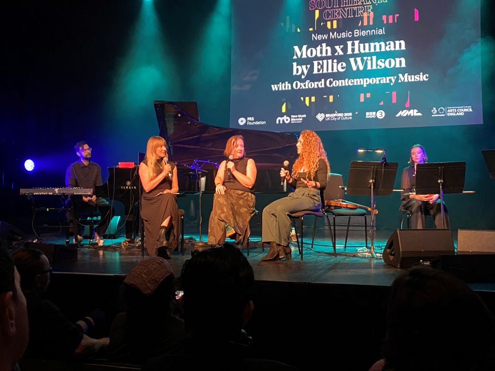 Five people on a stage, three in conversation, in front of a screen saying Moth x Human by Ellie Wilson with Oxford Contemporary Music