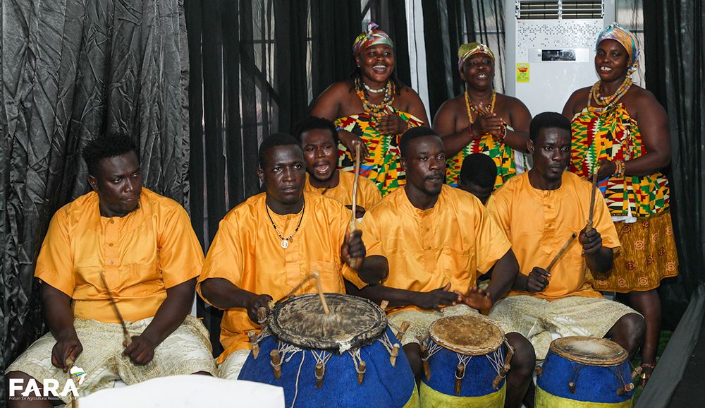 Drummers and singers from the Odikro Royals in matching outfits performing with traditional drums.