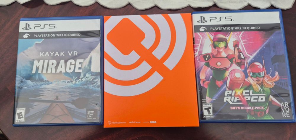 Three physical PS5 games on a table - Kayak VR: Mirage, C-Smash VRS, Pixel Dipped double pack