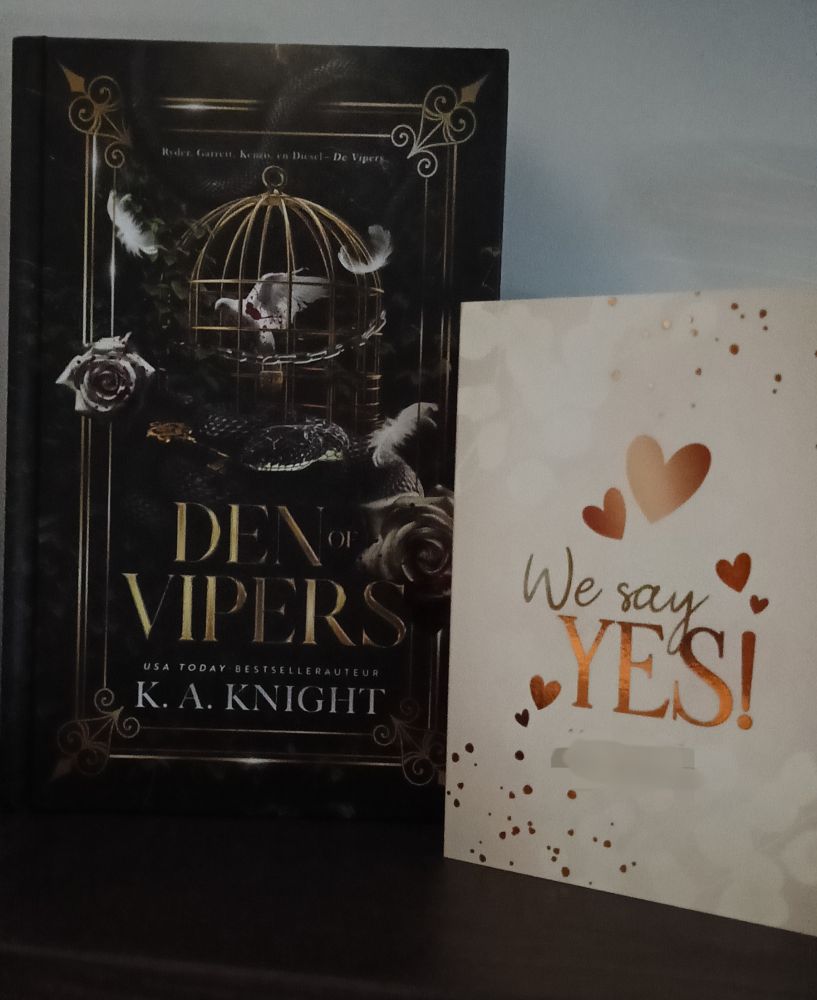 Den of Vipers (Dutch Special Edition) next to a Wedding invitation