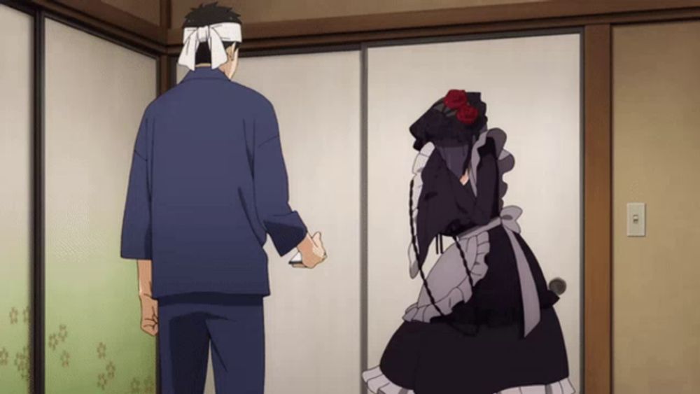 a man with a bandana around his head stands next to a woman in a maid outfit