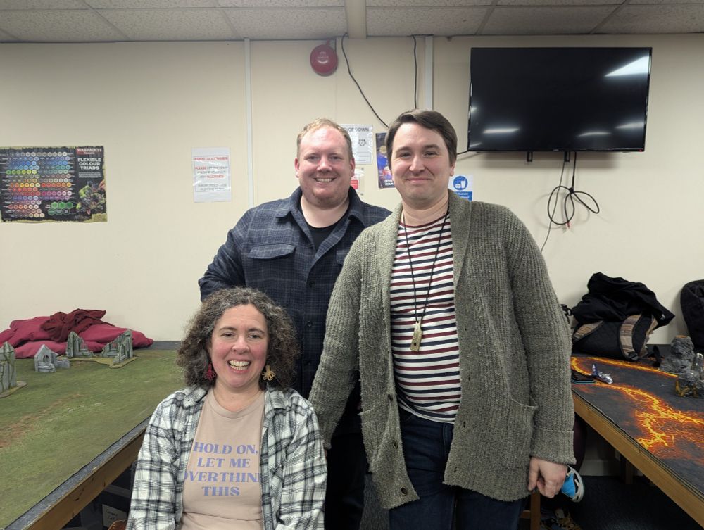 A photo of three people smiling for the camera.  