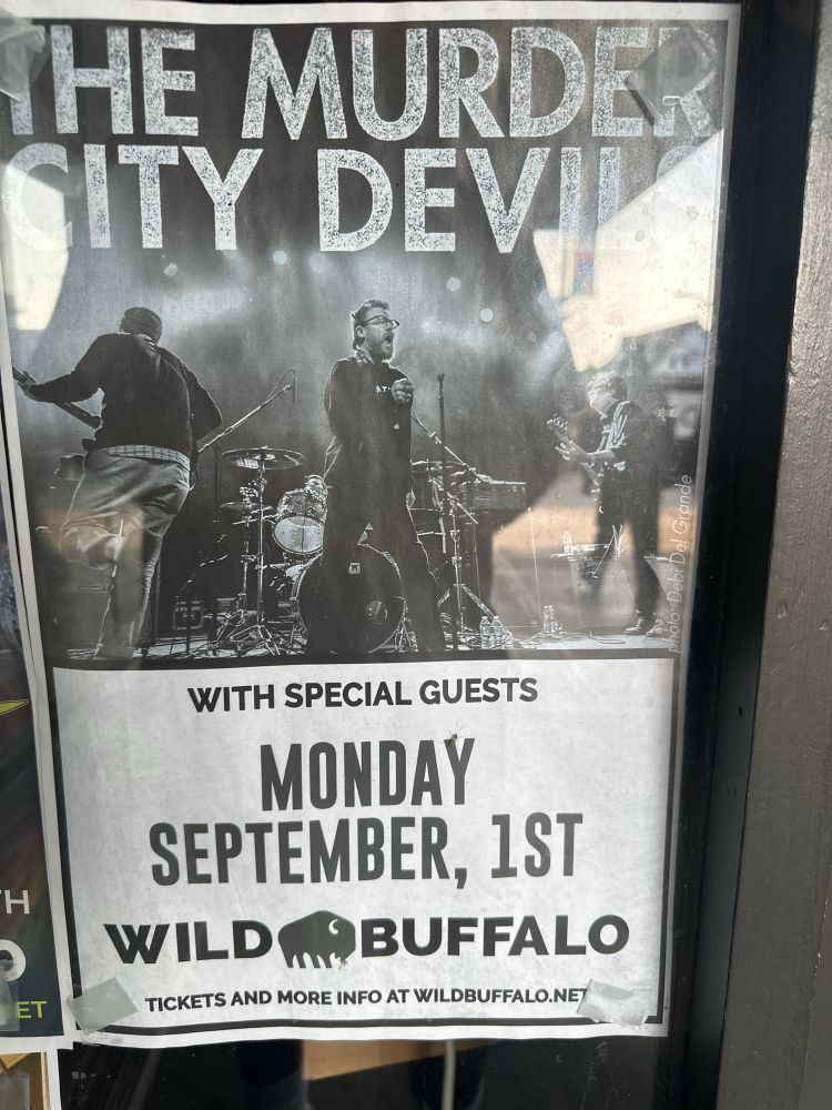 Poster in window for murder city devils in Bellingham Washington 