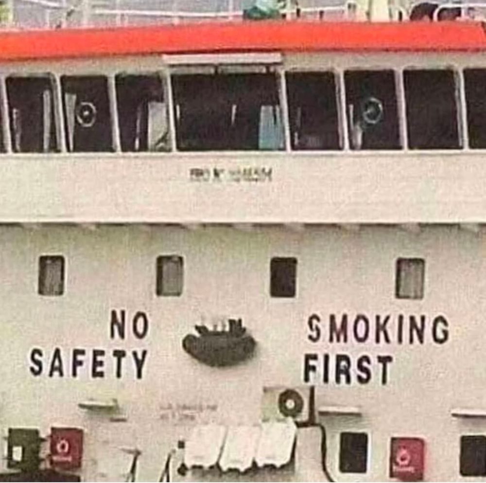 On the deck of a ferry, the wall says

         NO            SMOKING
SAFETY             FIRST

separated by something mounted on the outer wall 