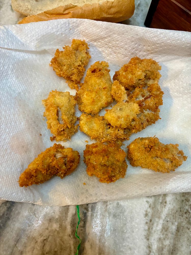 Golden breaded oysters on a paper towel 