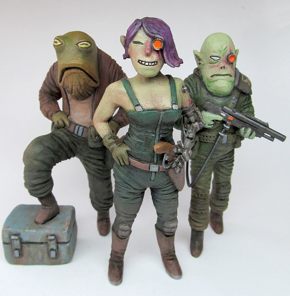 3 clay sculptures of space pirate characters on a white background.
