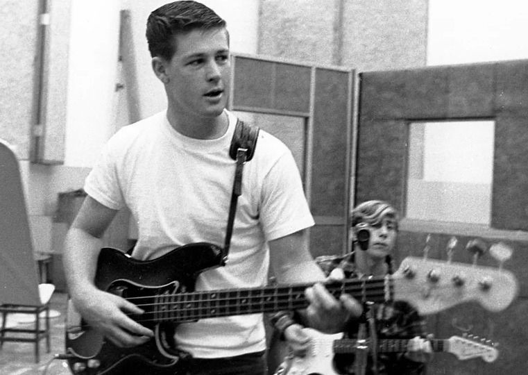 a young Brian Wilson in the studio playing 