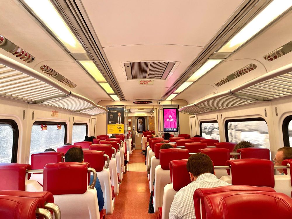 The interior of a Metro-North New Haven Line train, with people seated.