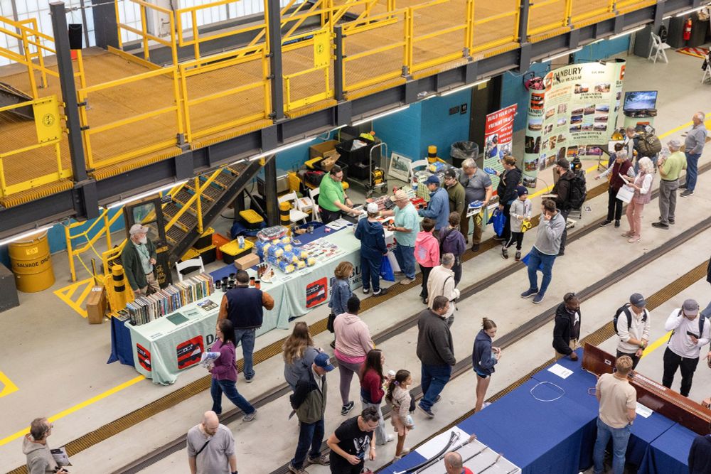 An overhead view of the New Haven Yard facility, with exhibits inside and people walking through.