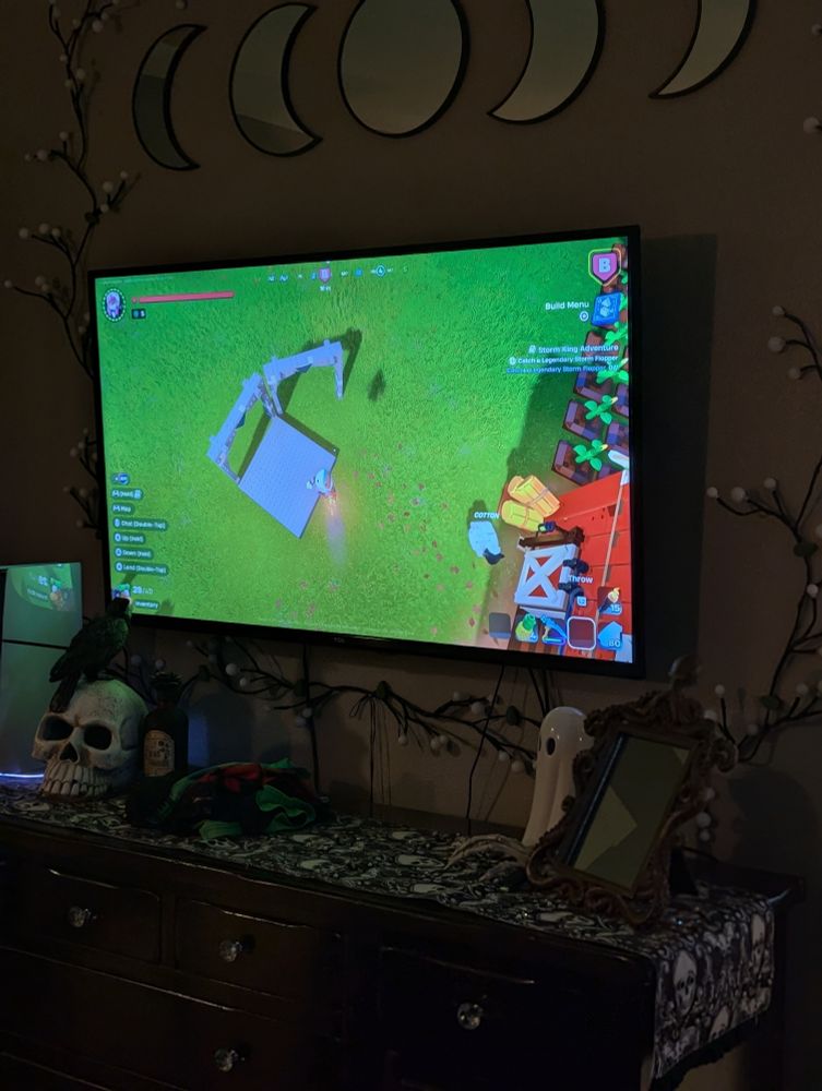My TV screen showing a build in Lego Fortnite. It is literally two arches and a foundation block and none of it makes sense. 