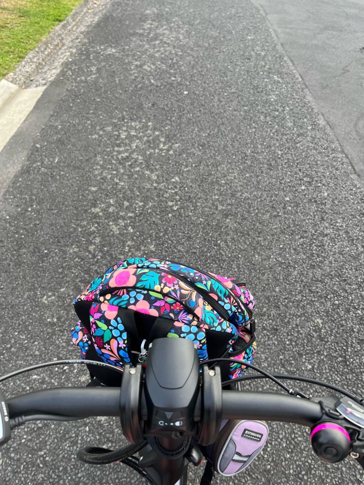 Bike handlebars and kids flower school bag on front rack