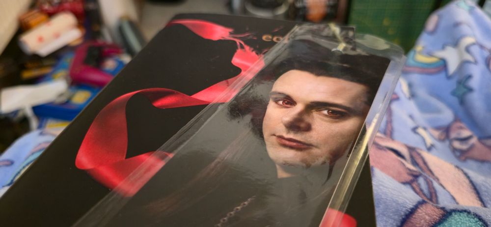 A copy of Eclipse by Stephanie Meyer with a bookmark of Michael Sheen as Aro on top.