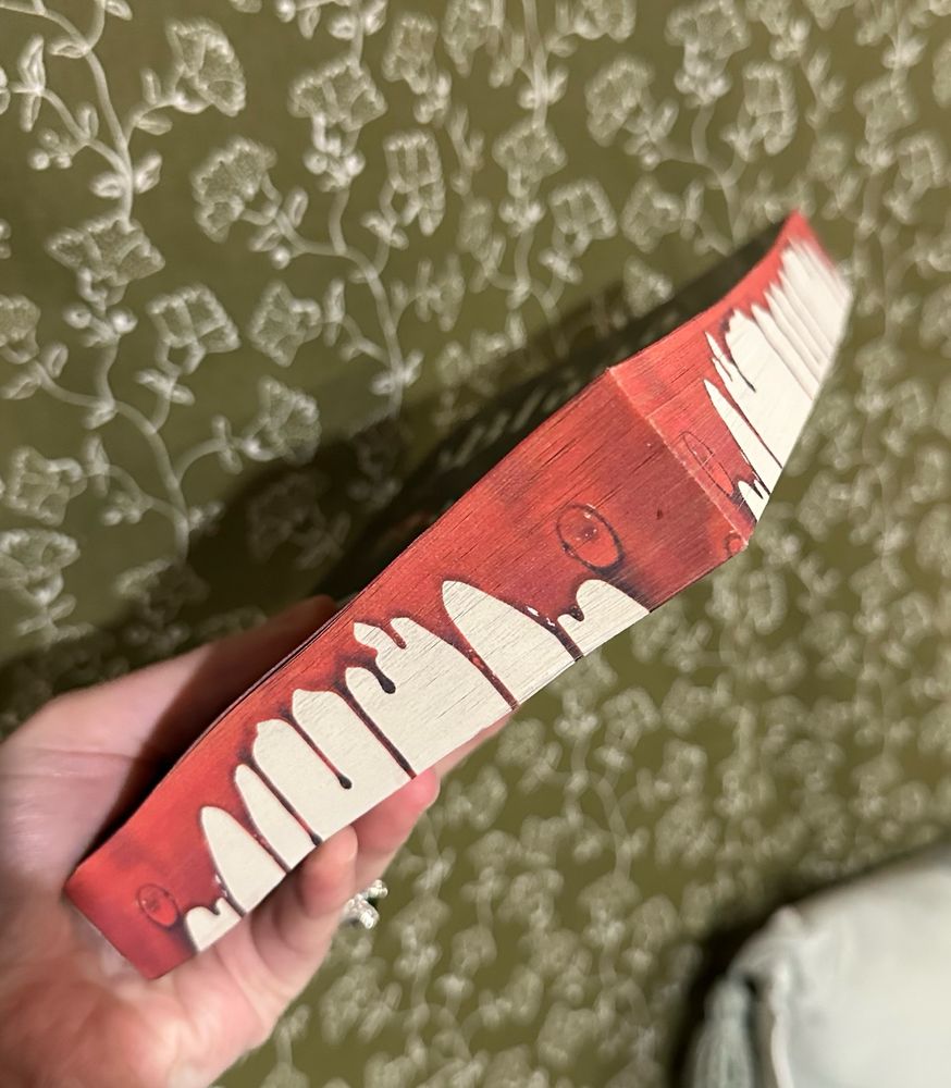 Side view of a book with sprayed edges. The pages look like they are bleeding