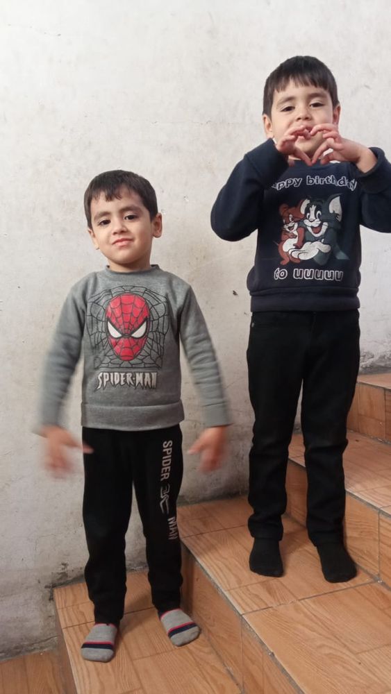 Saleh and Ahmed in Gaza. Ahmed is making a love heart with his fingers. 