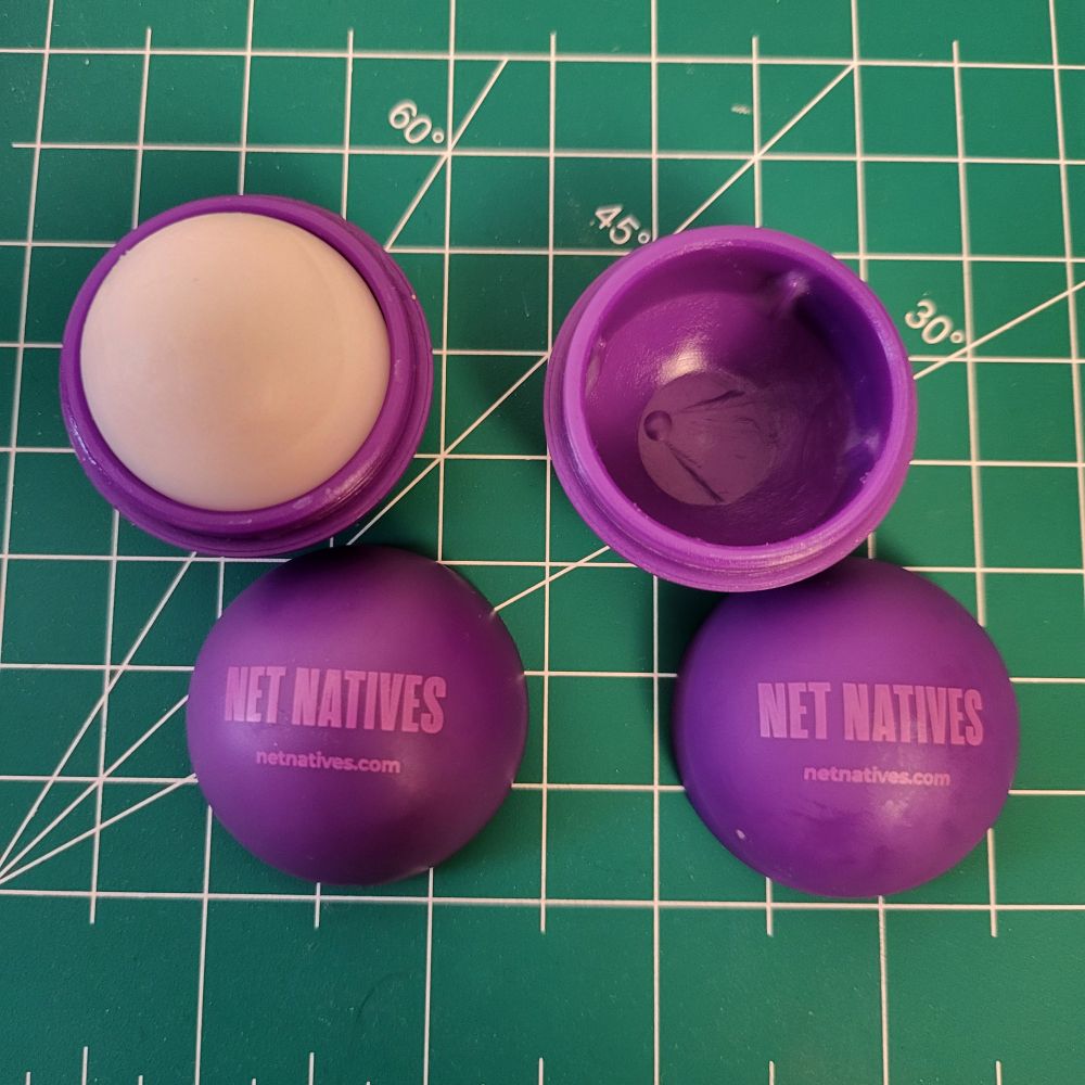 On the left is a new eos lip balm, on the right is a completely used, empty eos lip balm container.