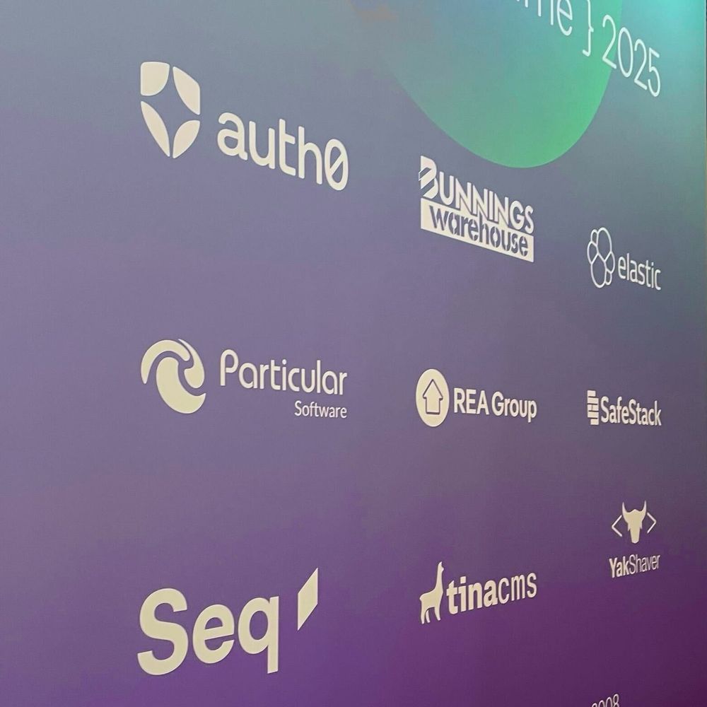 Sponsor logos on a poster at the event: Auth0, Bunnings Warehouse, Elastic, Particular Software, REA Group, SafeStack, Seq, TinaCMS, YakShaver