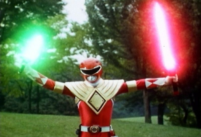 Mighty morphin red ranger wearing the dragon shield with glowing dragon dagger and swors